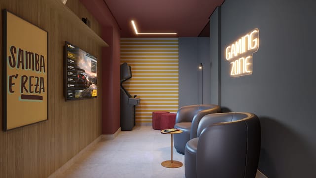 Salão de jogos com poltronas, videogame e o quadro escrito Samba é reza do Residencial Dona Ivone Lara, no Santo Cristo