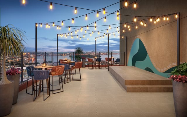 Bar no rooftop ao anoitecer do Residencial Pixinguinha — Carinhoso, no Santo Cristo